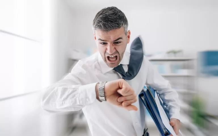 Stressed anxious businessman in a hurry checking time and running he is late for his business appointment