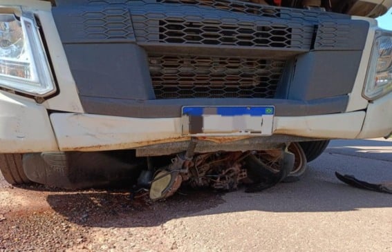 A motocicleta ficou presa embaixo da caçamba (Foto: Divulgação)